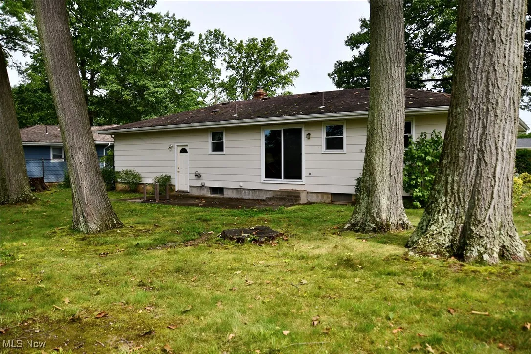 Back of property featuring a yard and a chimney