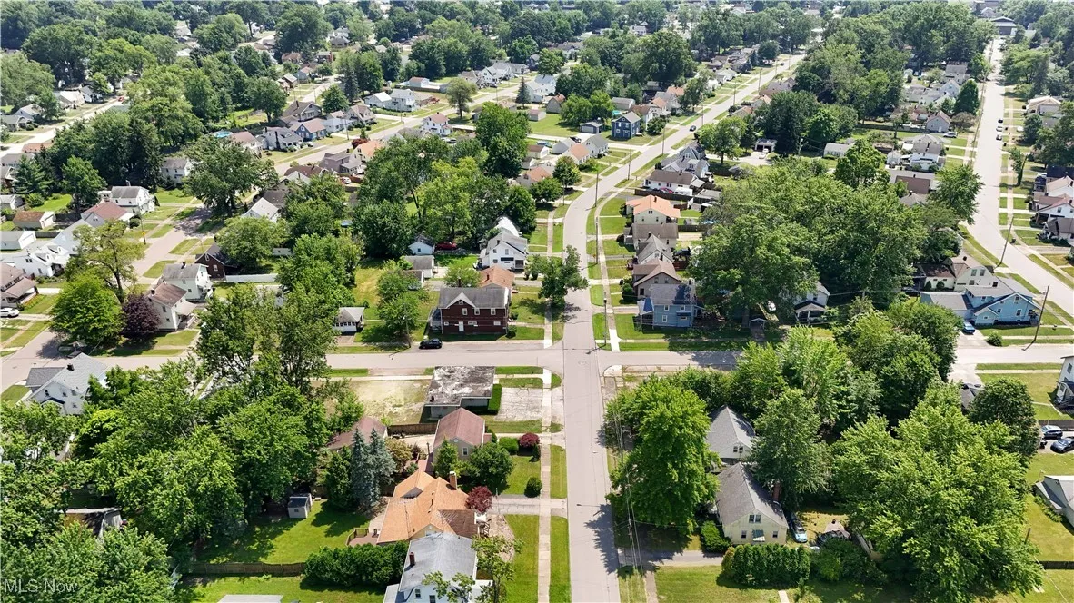 Aerial perspective of suburban area with a tree filled landscape