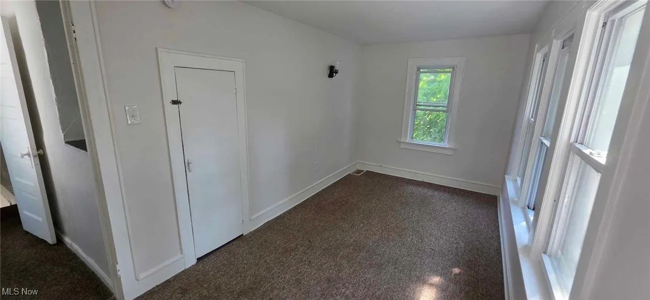 bedroom with dark colored carpet