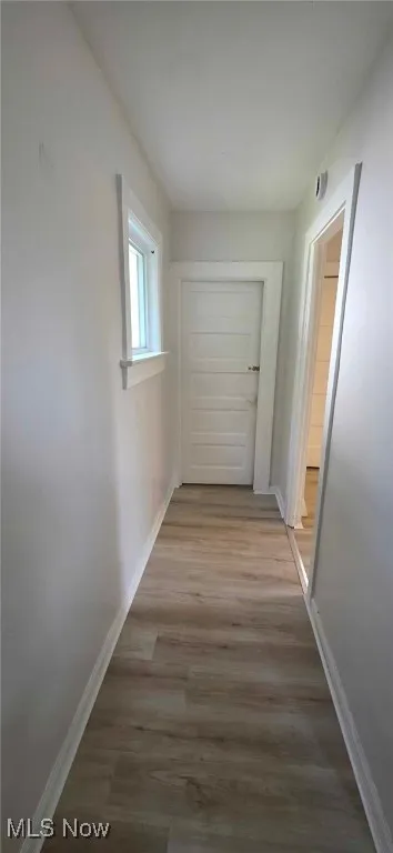 Hall featuring baseboards and lvt floors