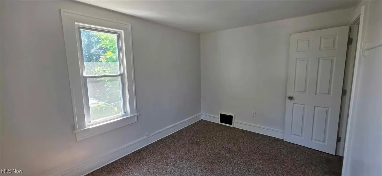 Carpeted bedroom featuring baseboards