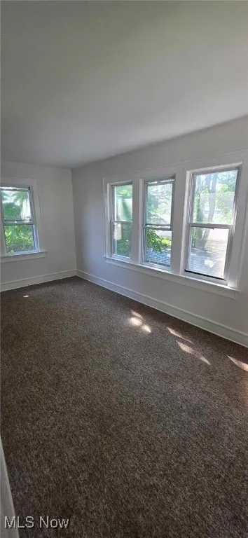 Carpeted bedroom featuring baseboards