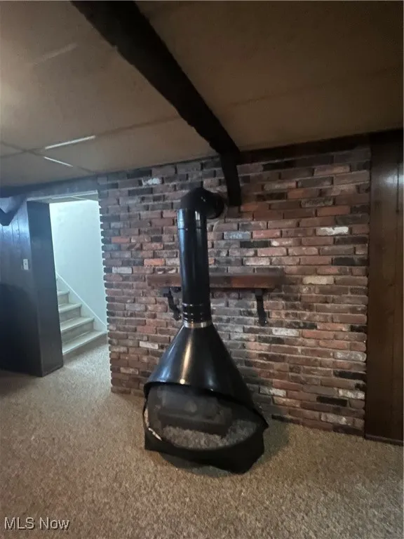 Basement fireplace, brick wall, stone flooring