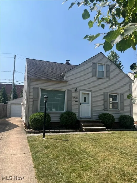 View of front of home, driveway and detached one car electric garage
