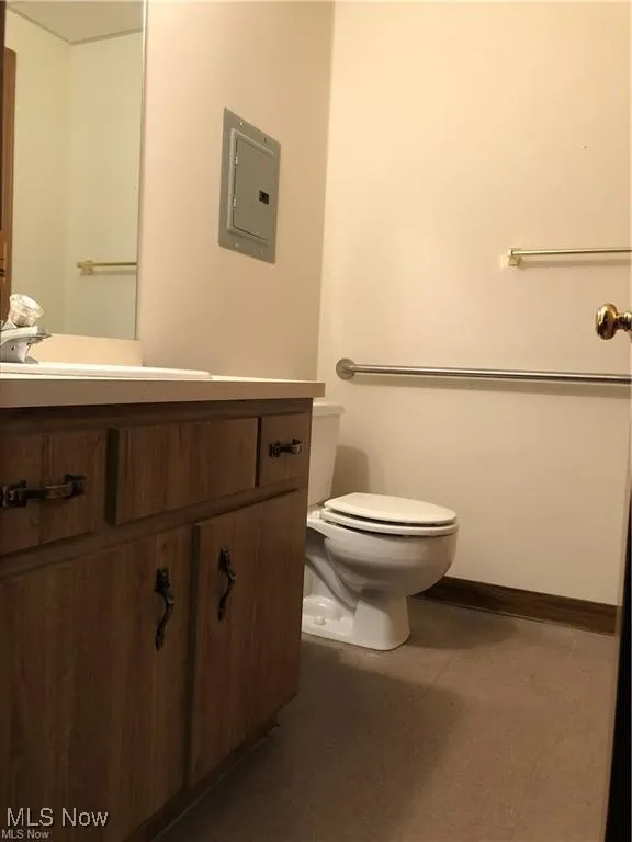 Bathroom with vanity, electric panel, and tile patterned floors