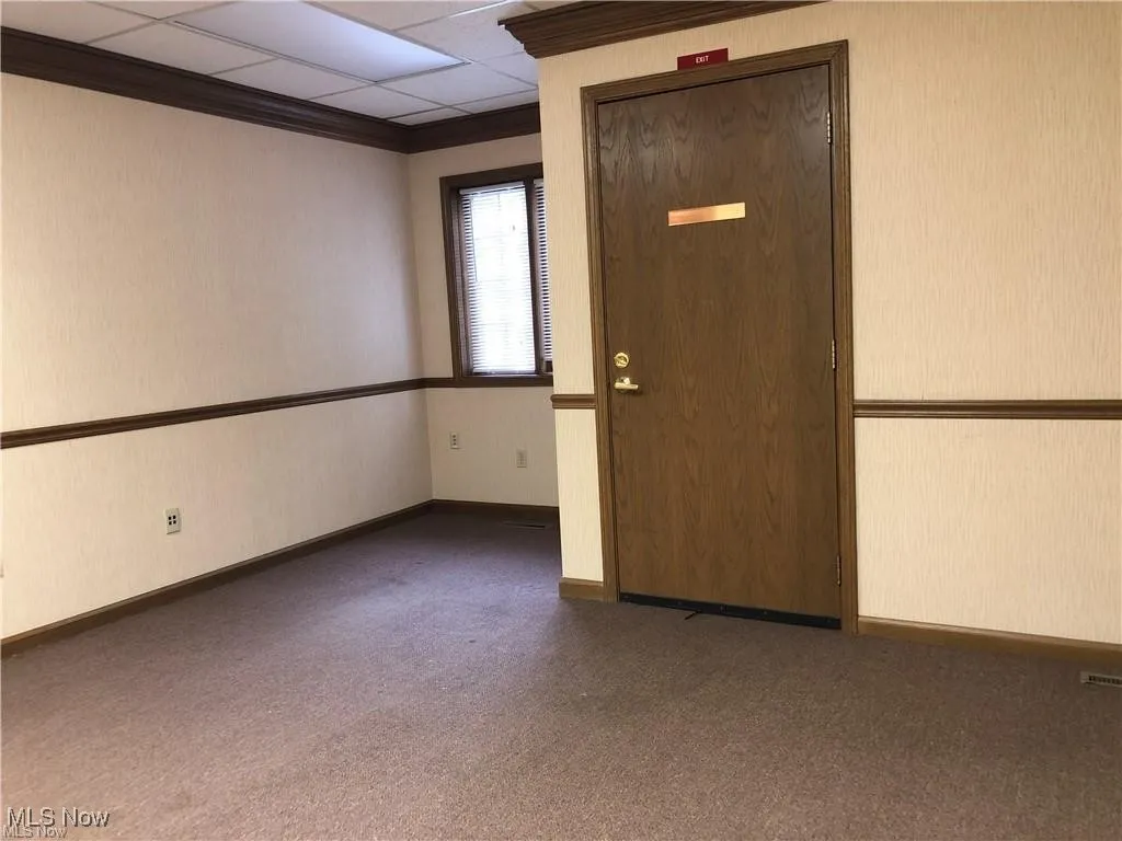 Carpeted spare room with baseboards