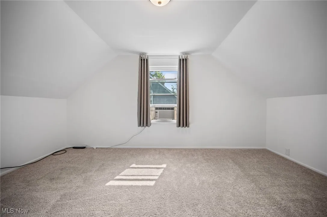 Bedroom featuring carpet floors and lofted ceiling
