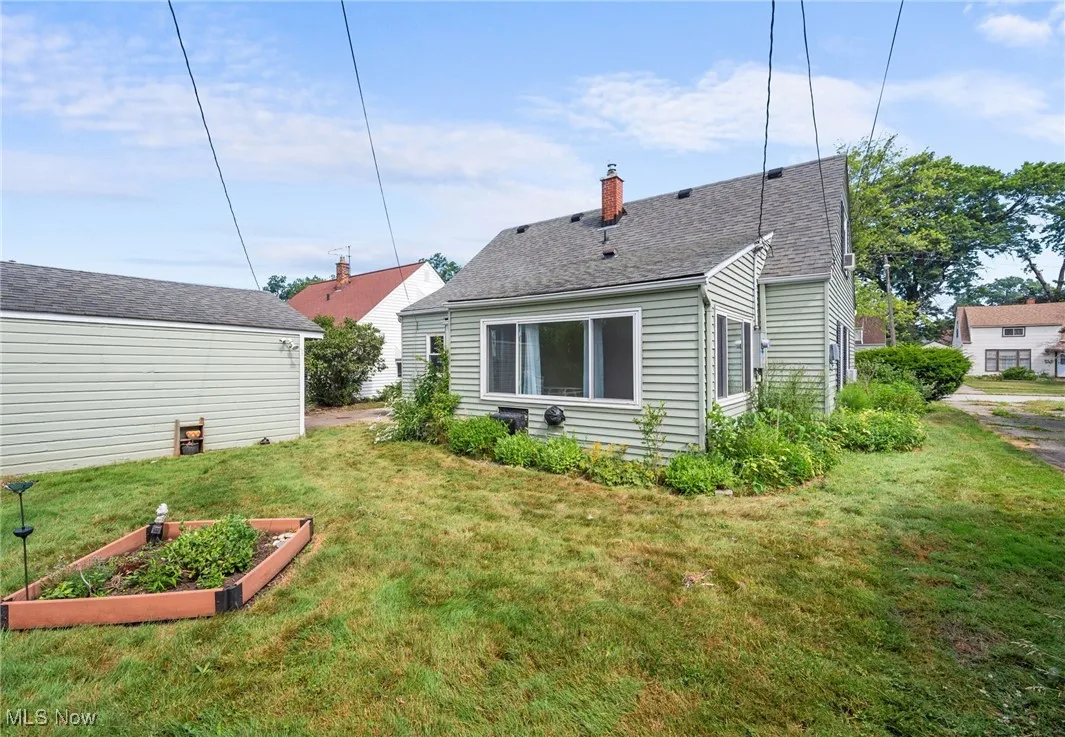 Back of property with a garden, and a yard