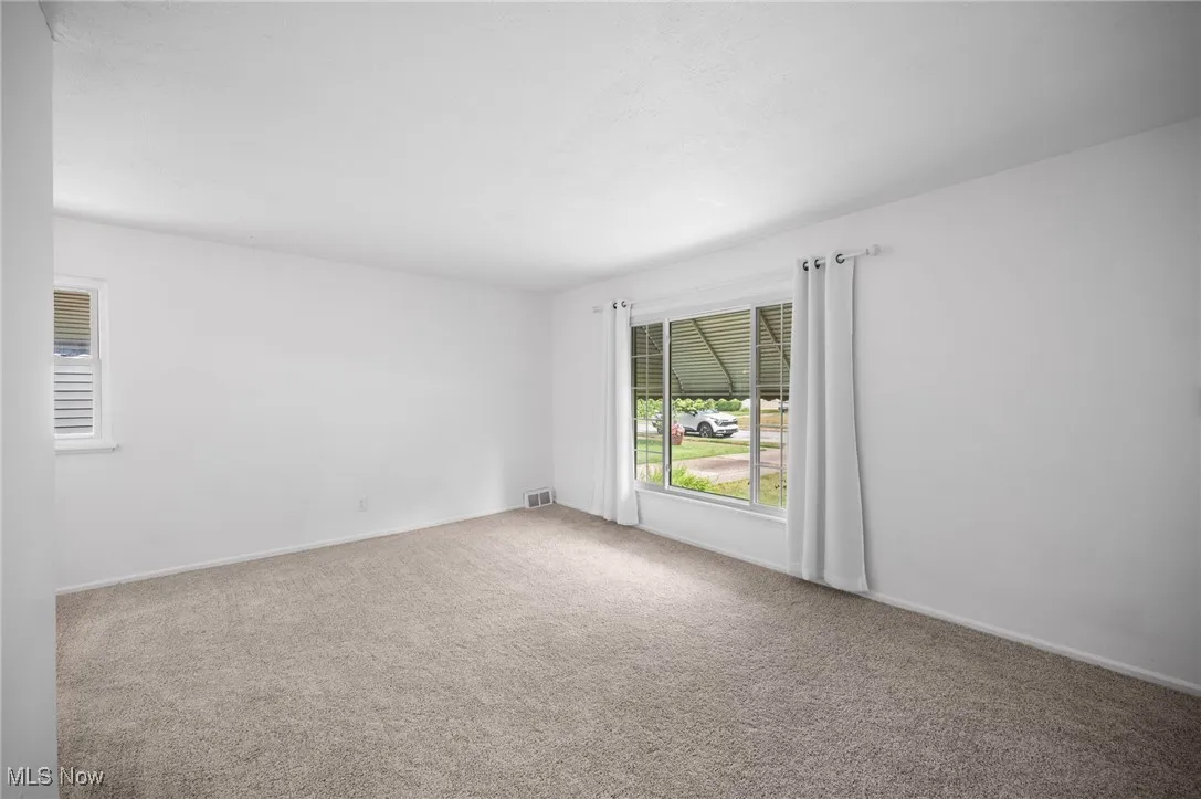 Living room featuring carpet flooring and baseboards