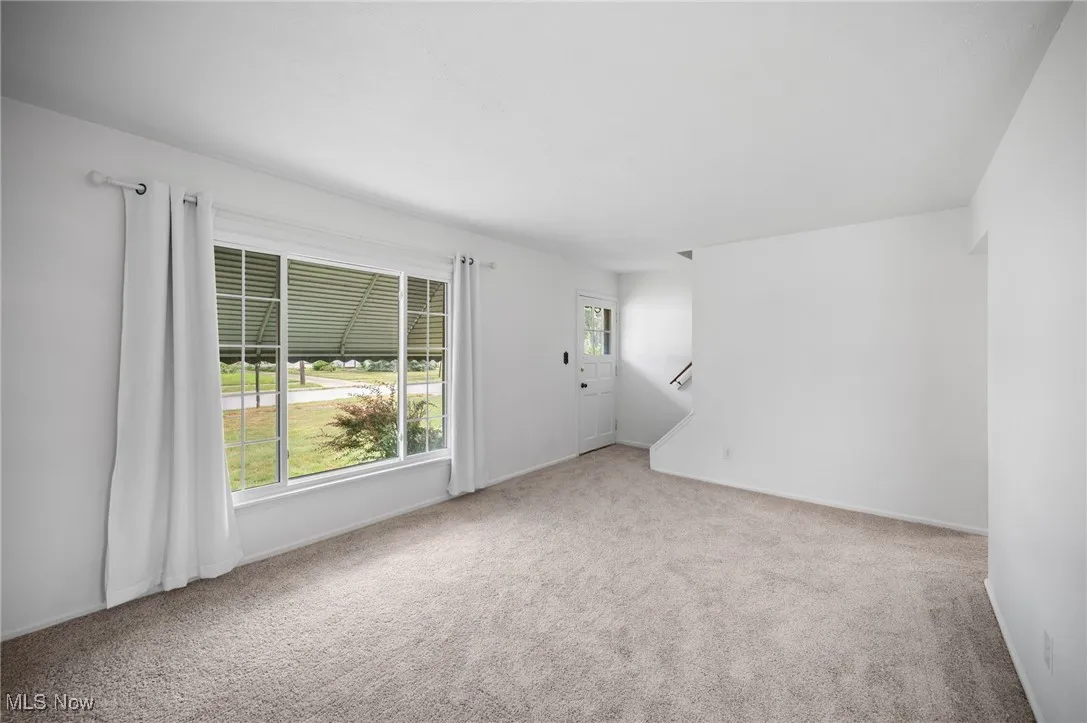 Living room with carpet floors and baseboards