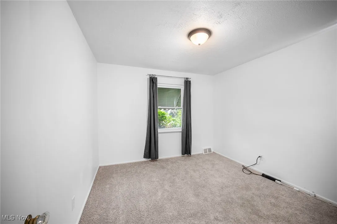 Bedroom featuring carpet flooring and a textured ceiling