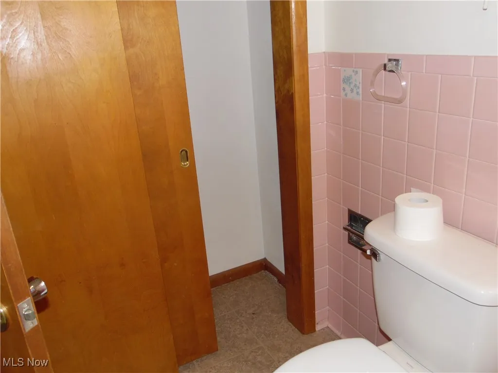Bathroom featuring tile walls and tile patterned flooring