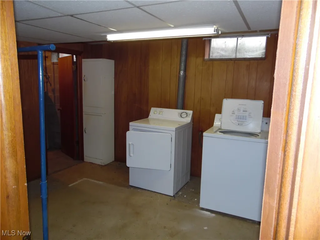 Washroom with independent washer and dryer and wooden walls