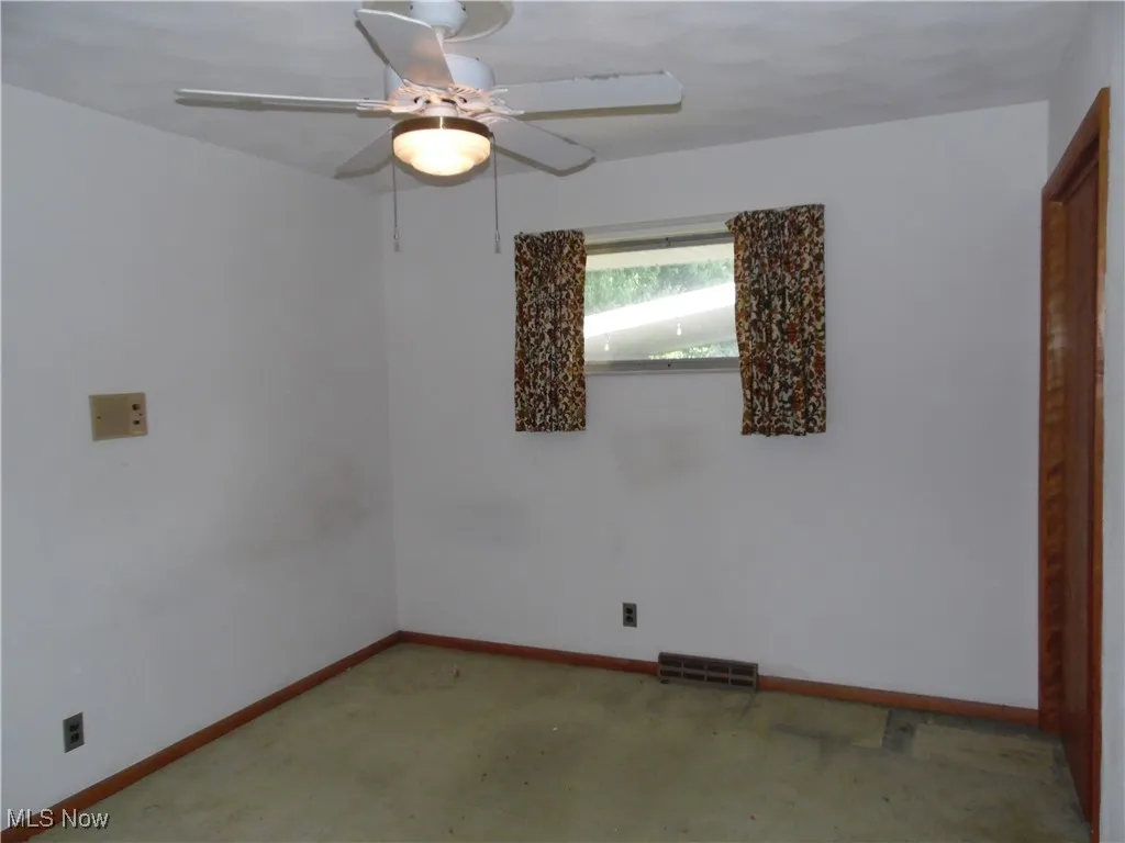 Spare room with carpet flooring and a ceiling fan