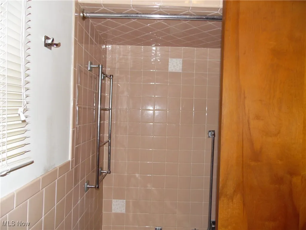 Full bathroom with a tile shower