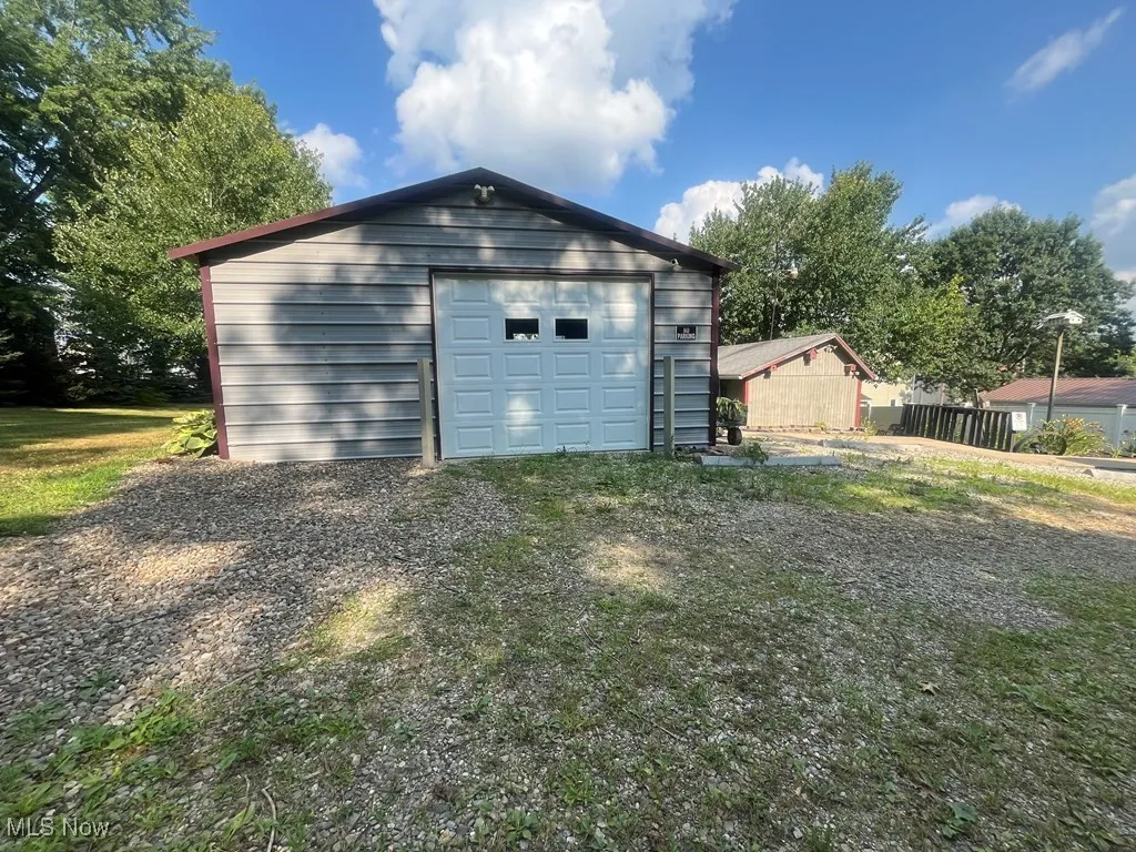 Detached garage with gravel driveway