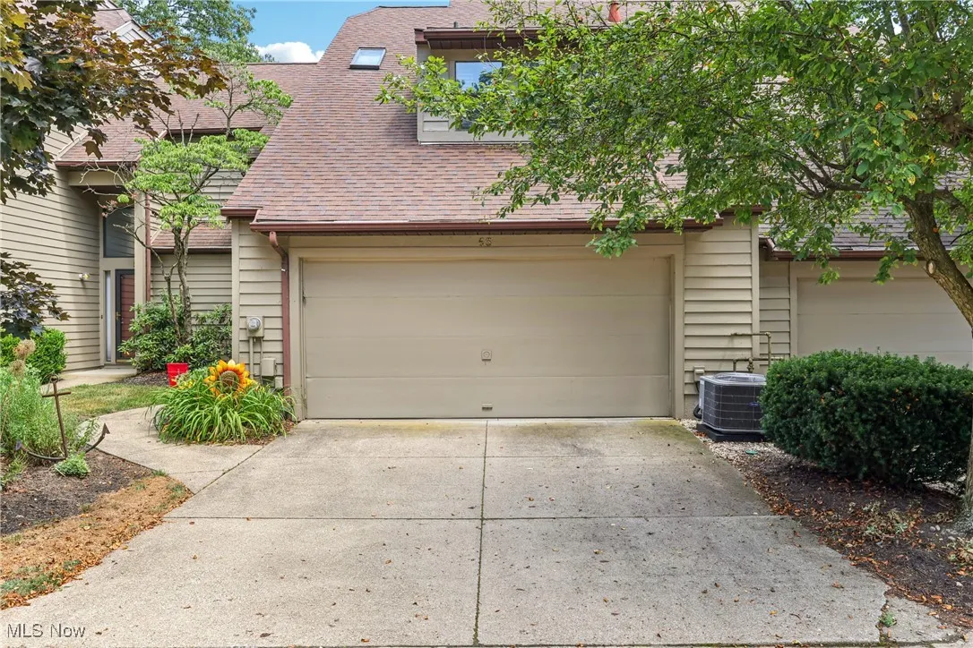 Front of the condo with a 2 car attached garage