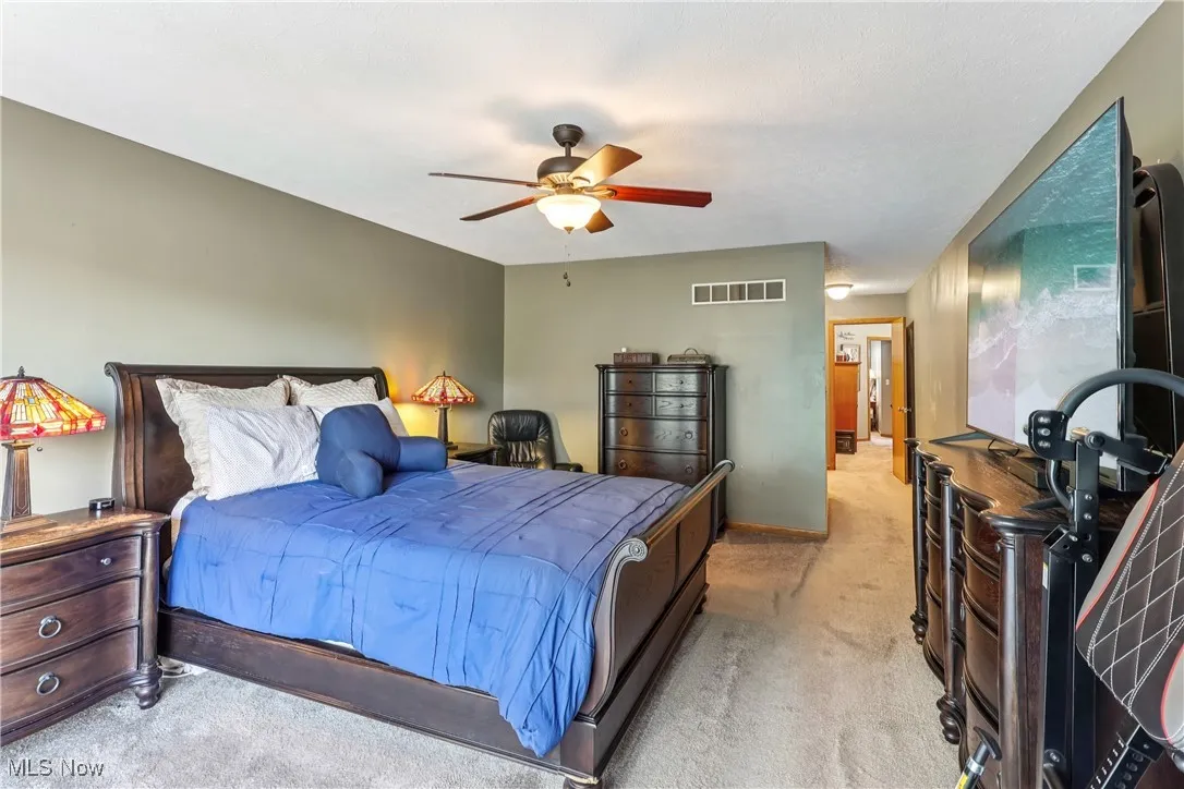 Bedroom featuring a ceiling fan / light and carpet flooring