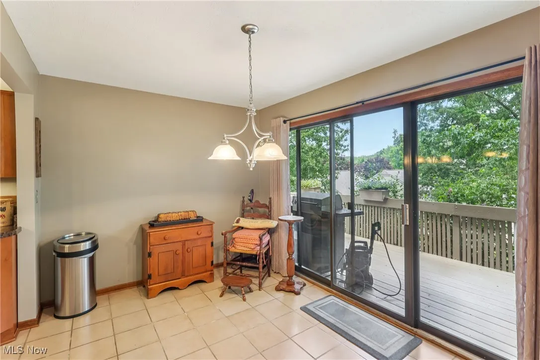 Dining area with chandelier and sliding glass door out to deck
