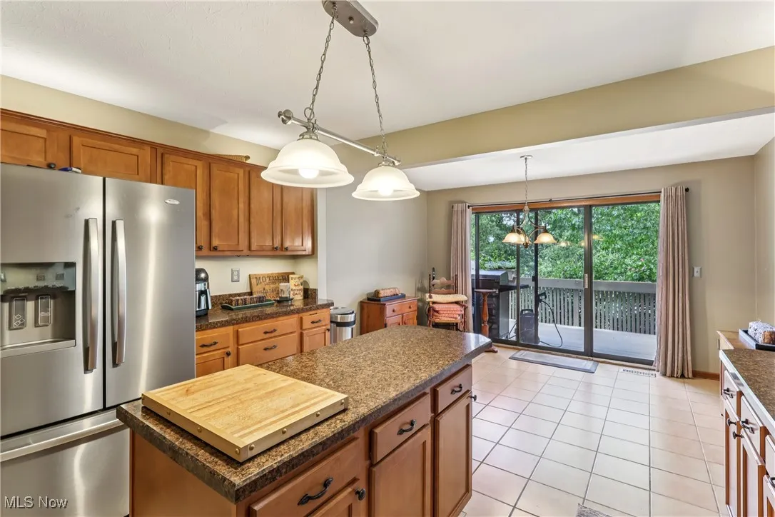 Eat-in kitchen featuring stainless steel refrigerator, center island and a dining area