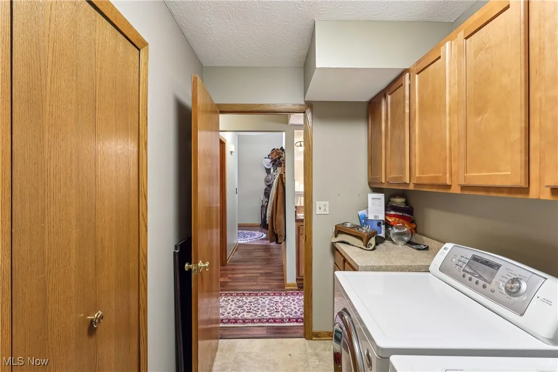 First floor laundry with cupboards and a closet