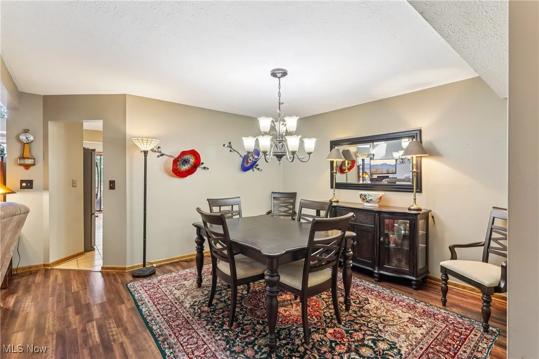 Dining room with a chandelier and laminate flooring