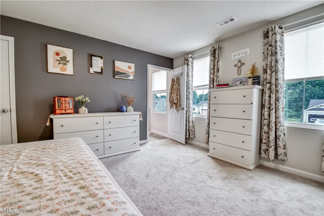 Carpeted bedroom with baseboards