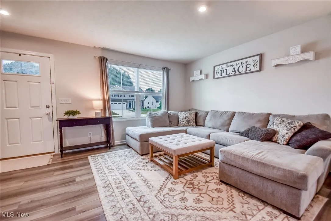 Living area featuring light wood-style floors and recessed lighting