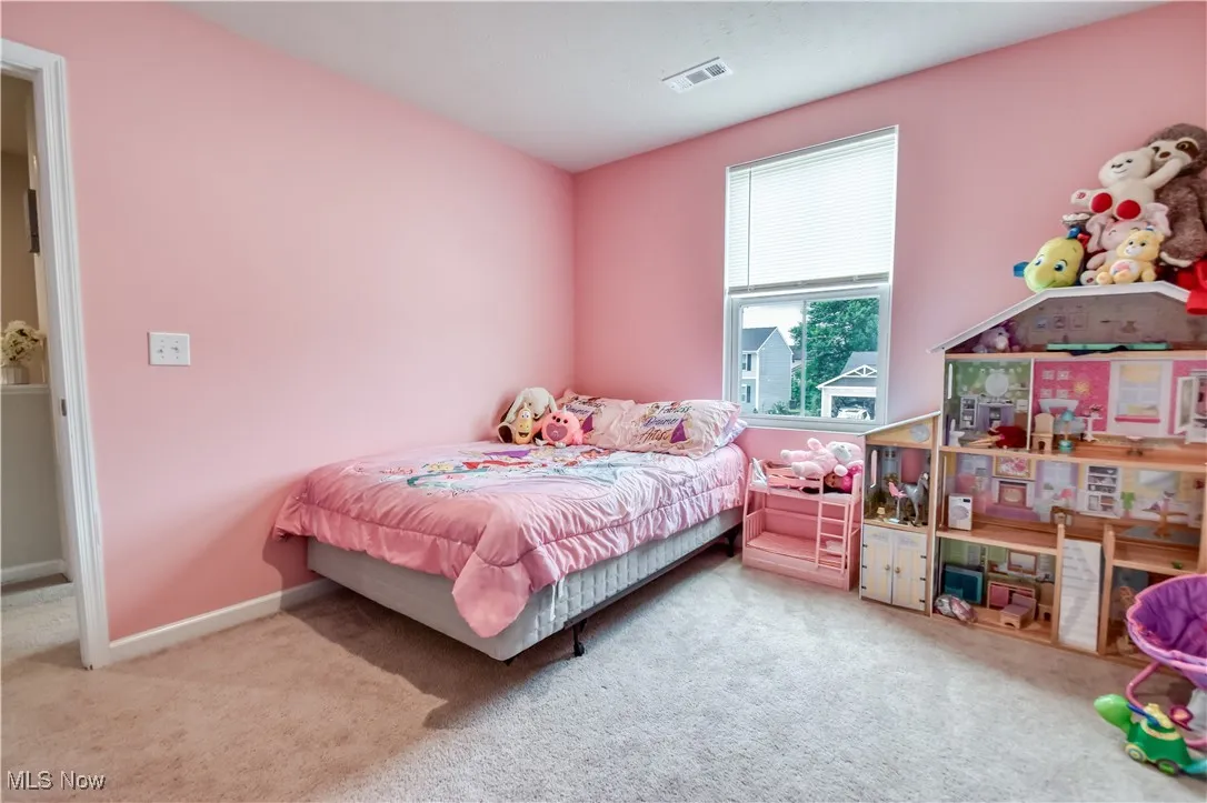 Carpeted bedroom with baseboards