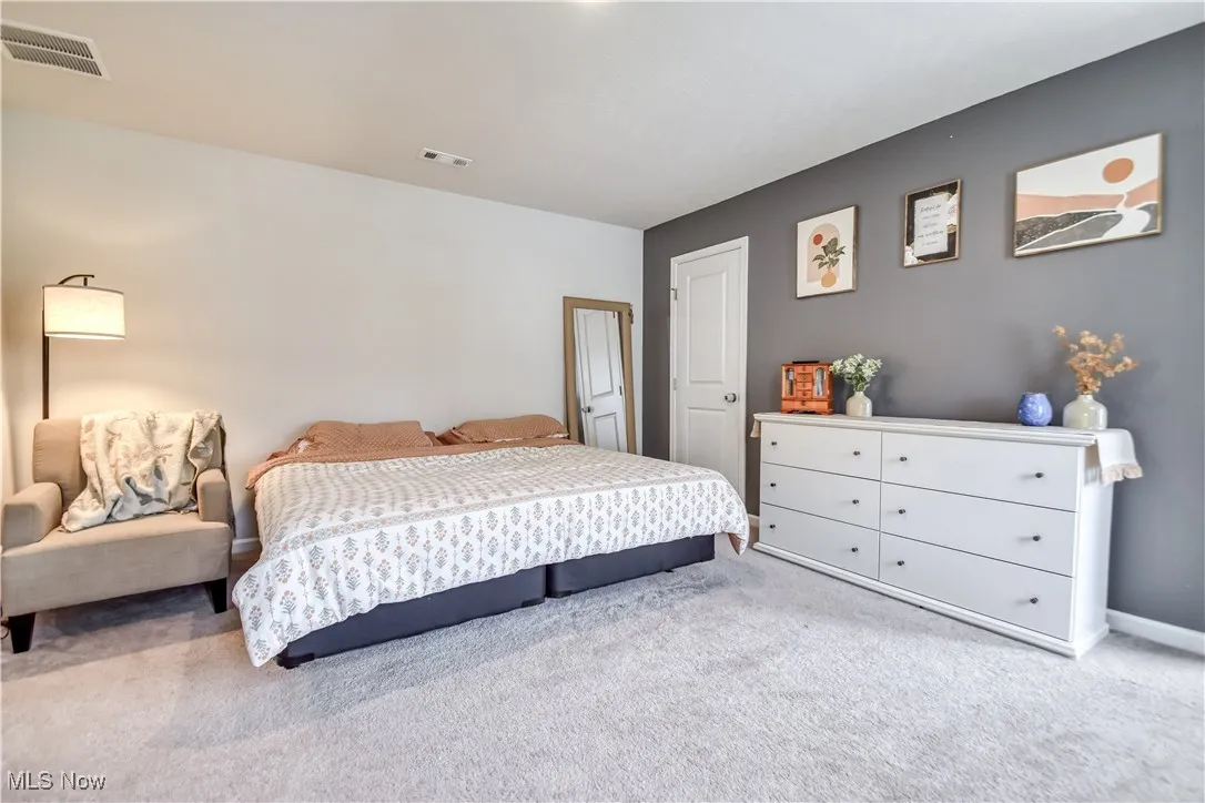 Carpeted bedroom featuring baseboards