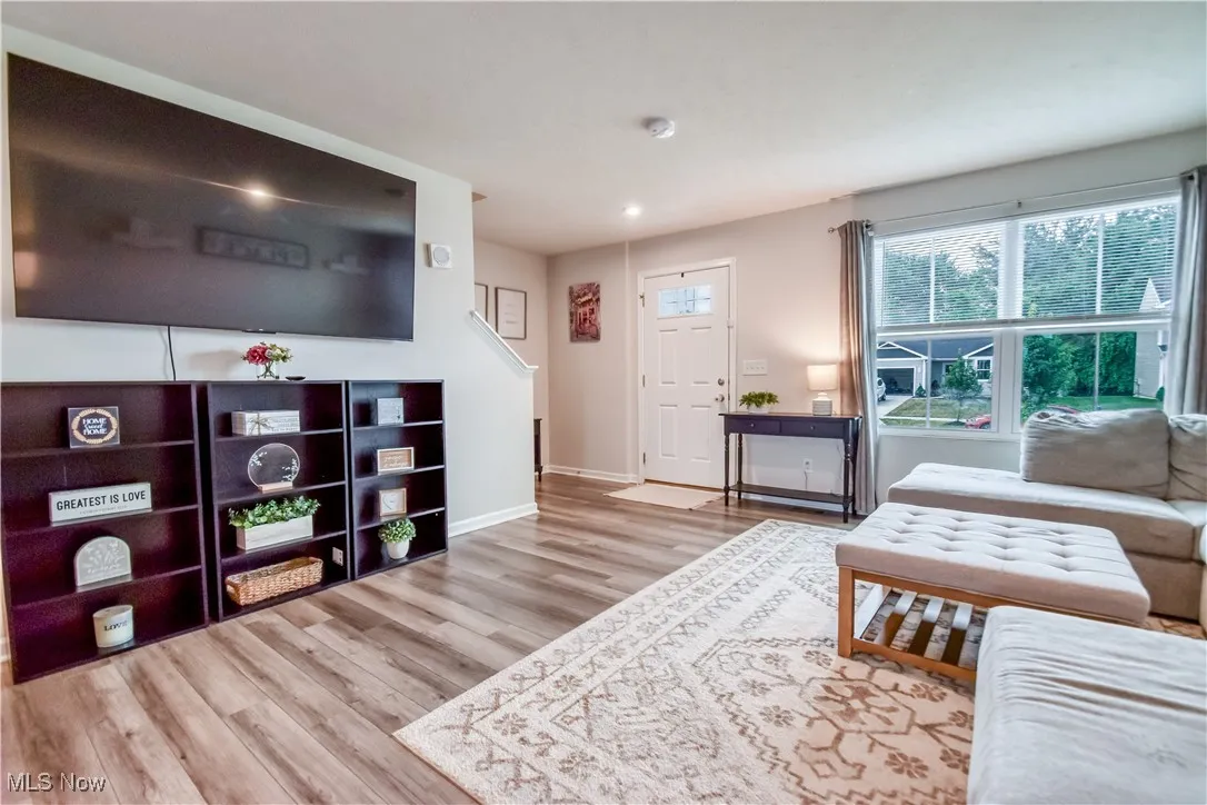Living area featuring wood finished floors and recessed lighting