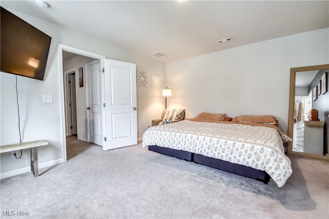 Carpeted bedroom featuring baseboards