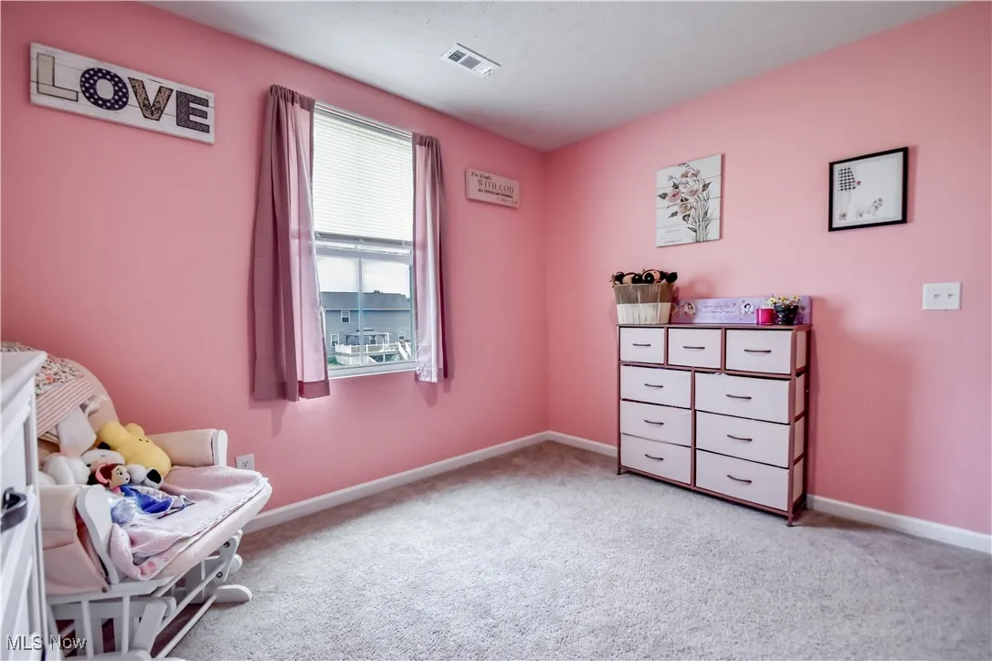 Living area with light colored carpet