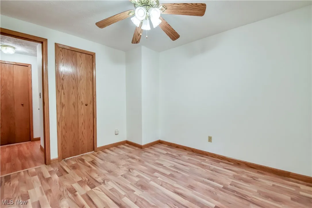 Unfurnished bedroom with light wood-style flooring and a ceiling fan