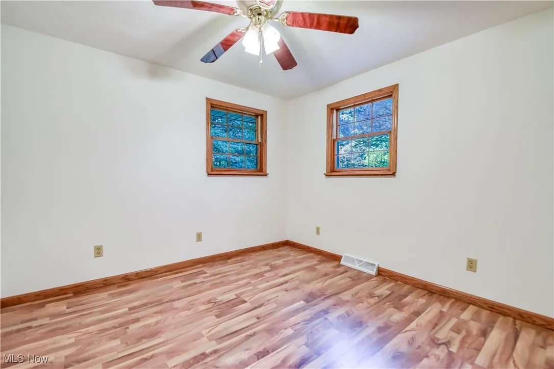 Spare room with light wood-style floors and ceiling fan