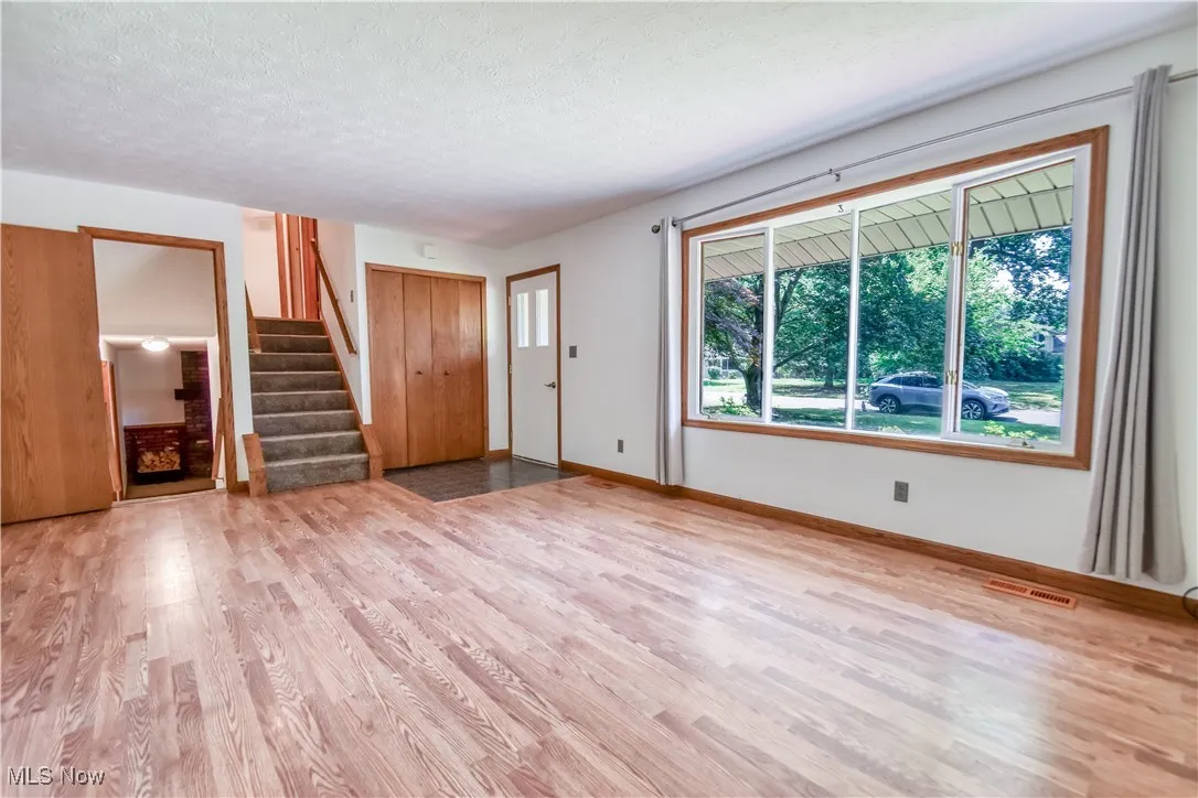 Foyer entrance featuring wood finished floors, a textured ceiling, and stairway