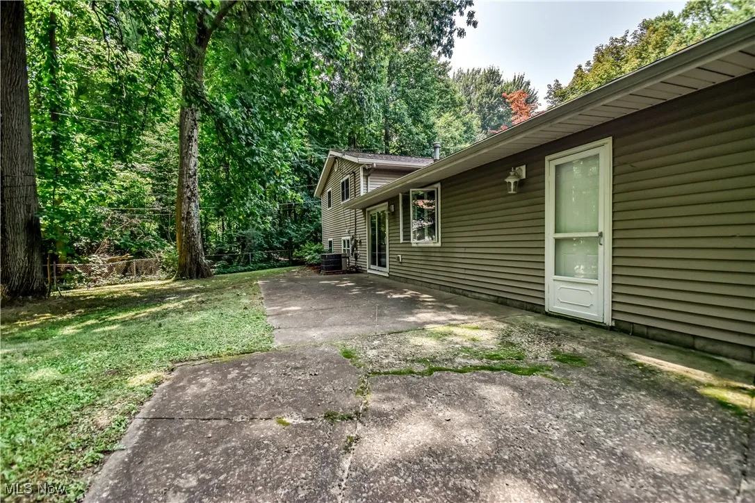 View of home's exterior with a patio and a yard