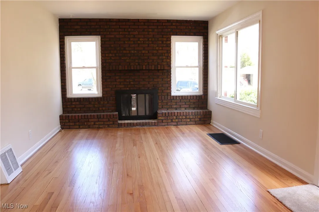 Living room from different direction showing fireplace.