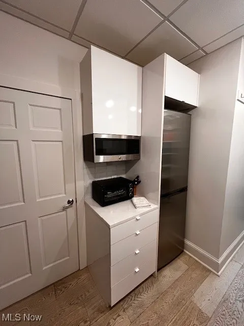 Office Kitchen featuring stainless steel refrigerator and microwave