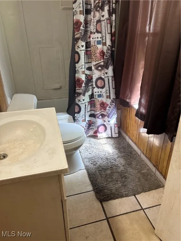 Full bath with vanity, tile patterned flooring, and a shower with shower curtain