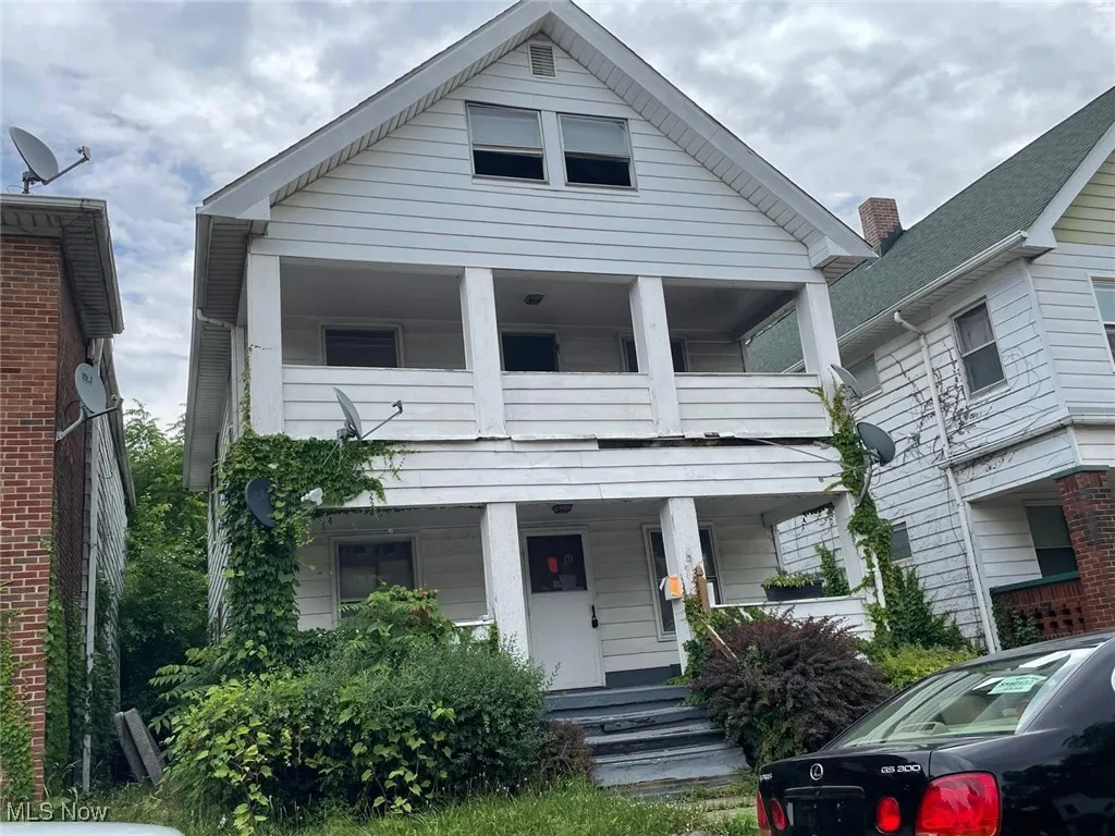 View of front of house with a balcony and covered porch