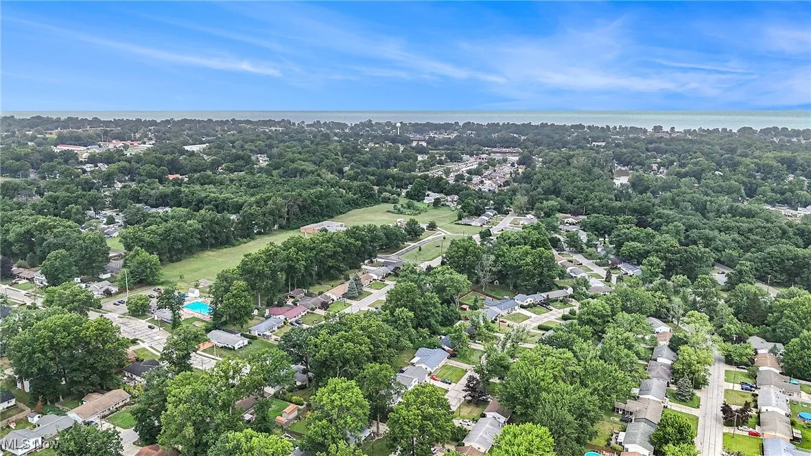 Aerial overview of property's location with a tree filled landscape
