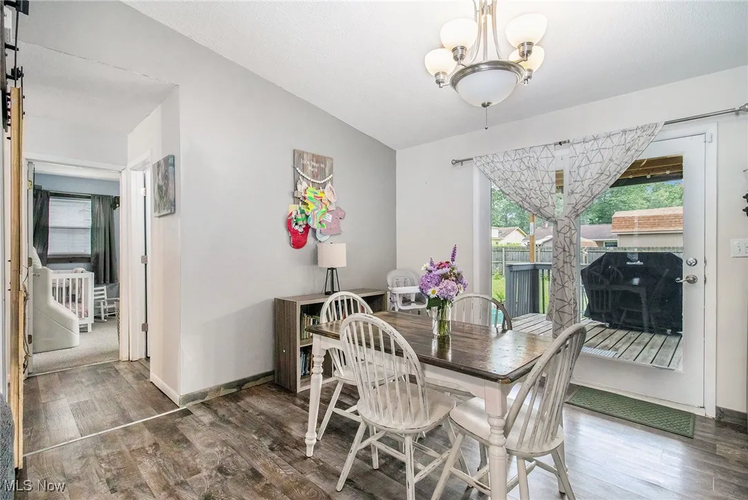 Dining area featuring wood finished floors, and vaulted ceiling