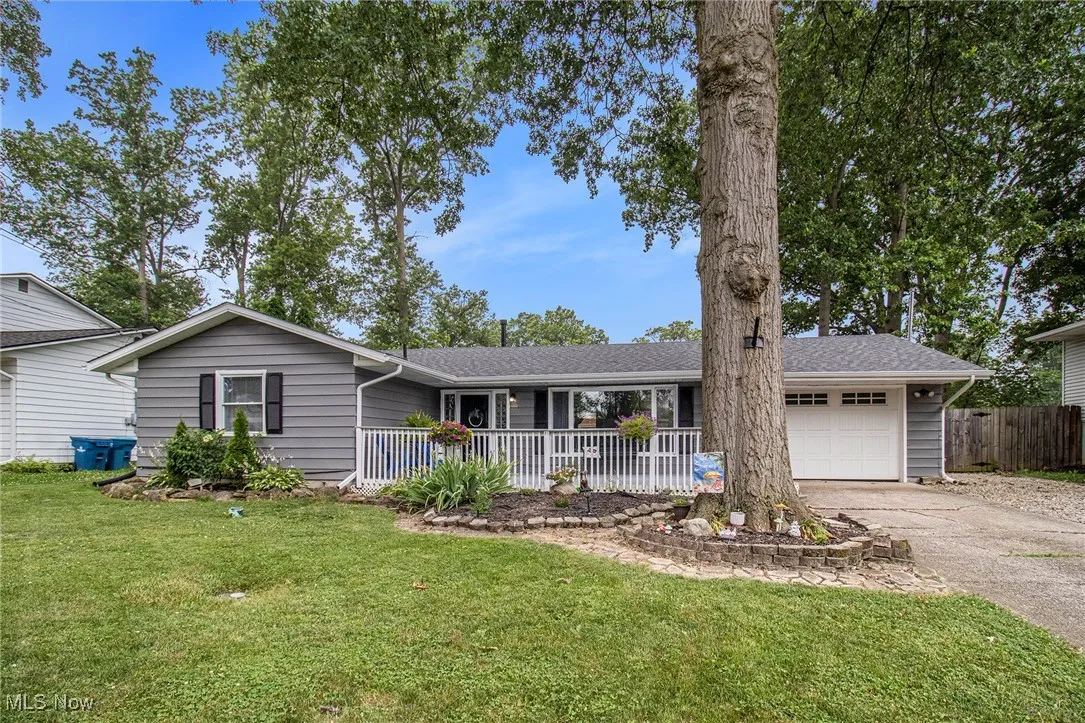Ranch-style home featuring  an attached garage, and driveway