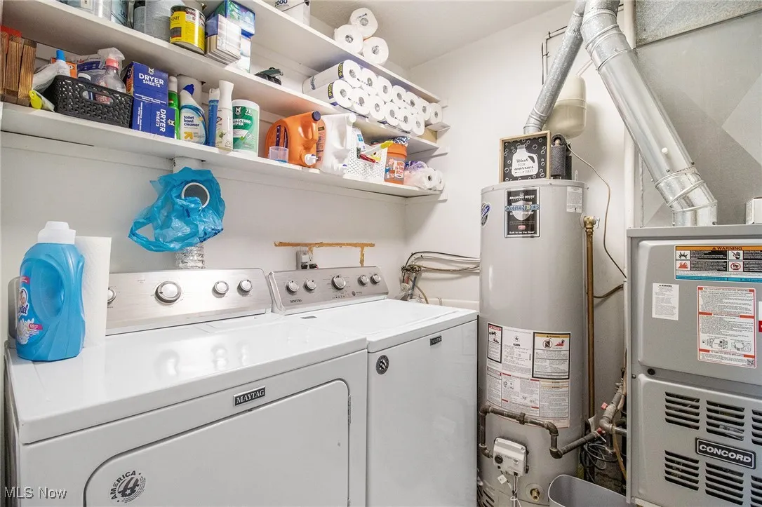 Laundry room with gas water heater, washer and dryer, and heating unit