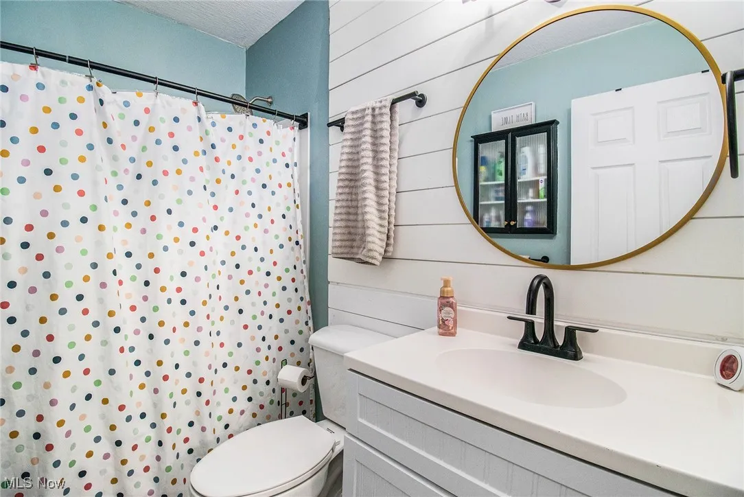 Bathroom featuring vanity, curtained shower