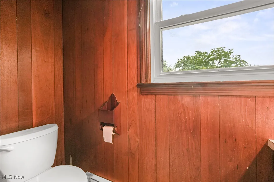 Bathroom featuring plenty of natural light and wooden walls