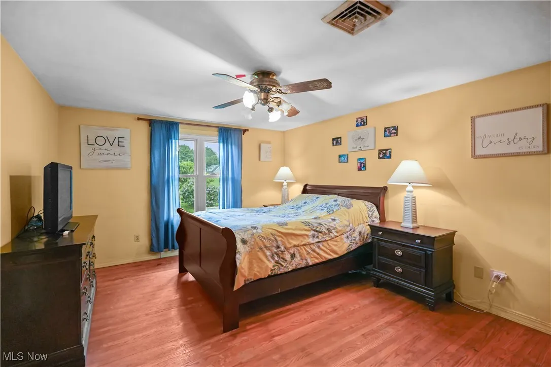 Bedroom with light wood-style floors and ceiling fan