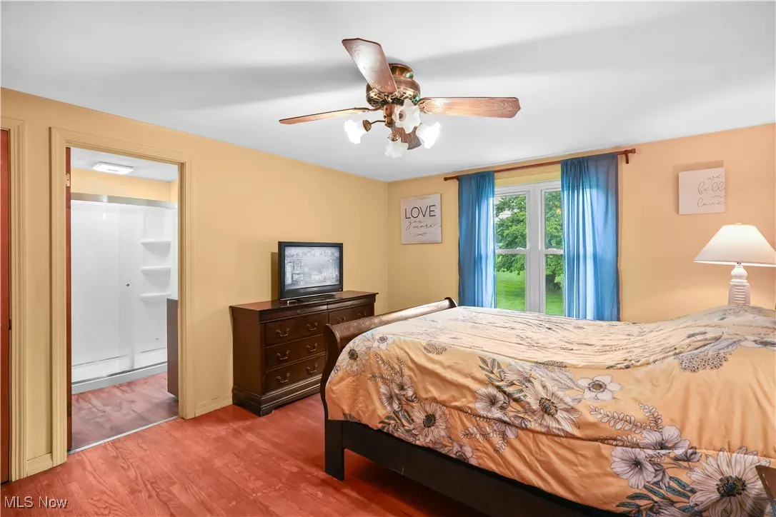 Bedroom with wood finished floors and a ceiling fan