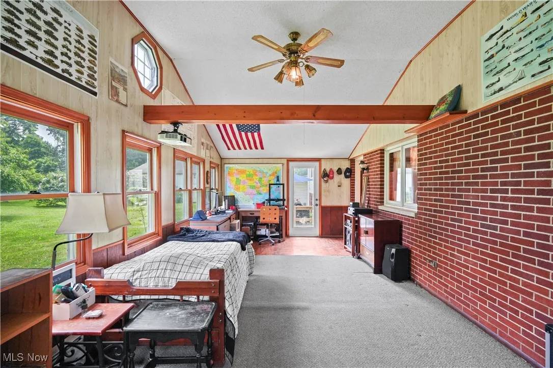 Sunroom featuring ceiling fan and plenty of natural light